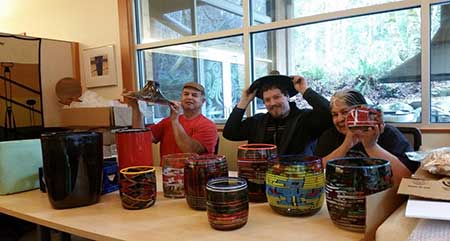 Photo of glass artists displaying their work